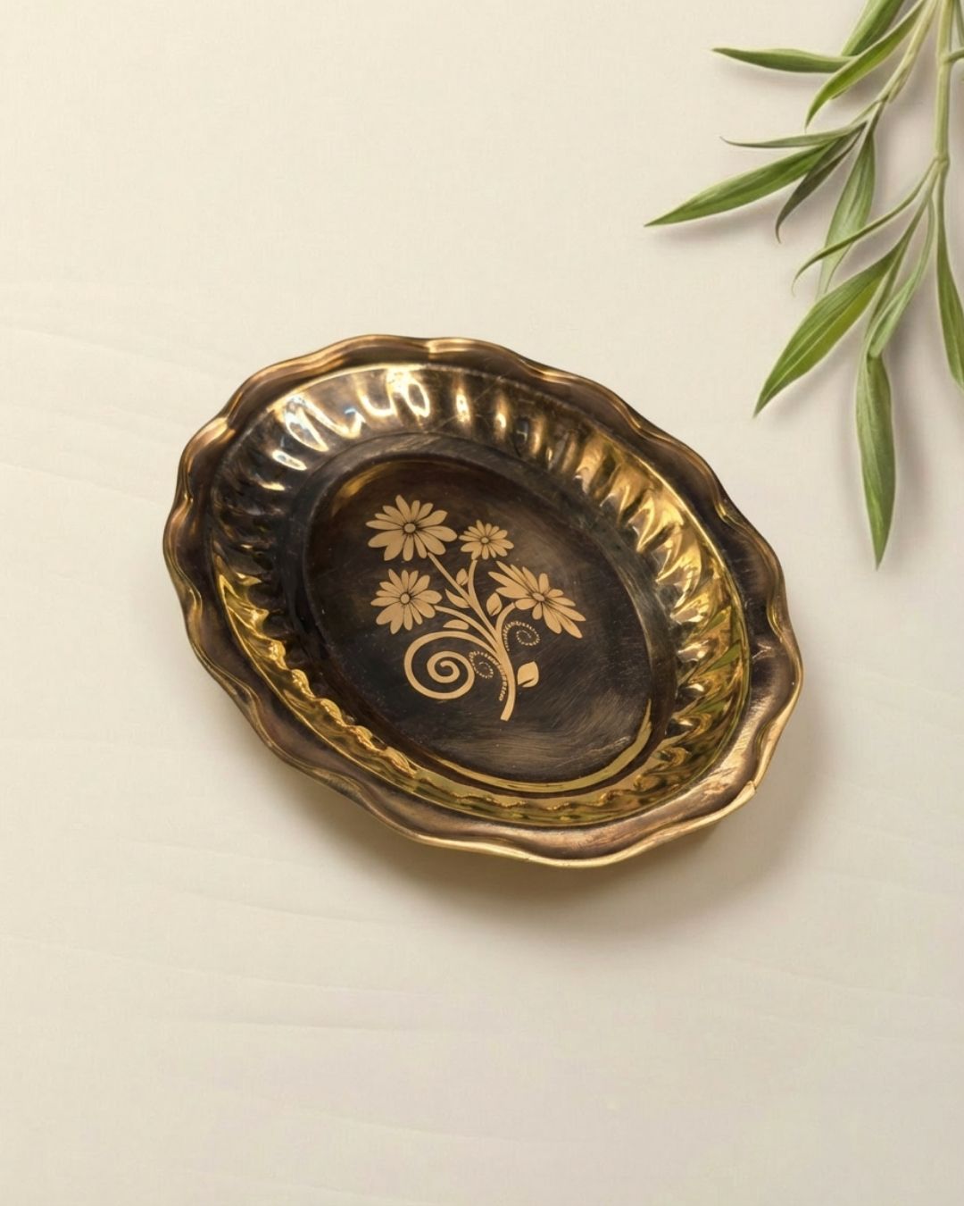 Graceful brass plate in oval shape with flower laser print in the middle