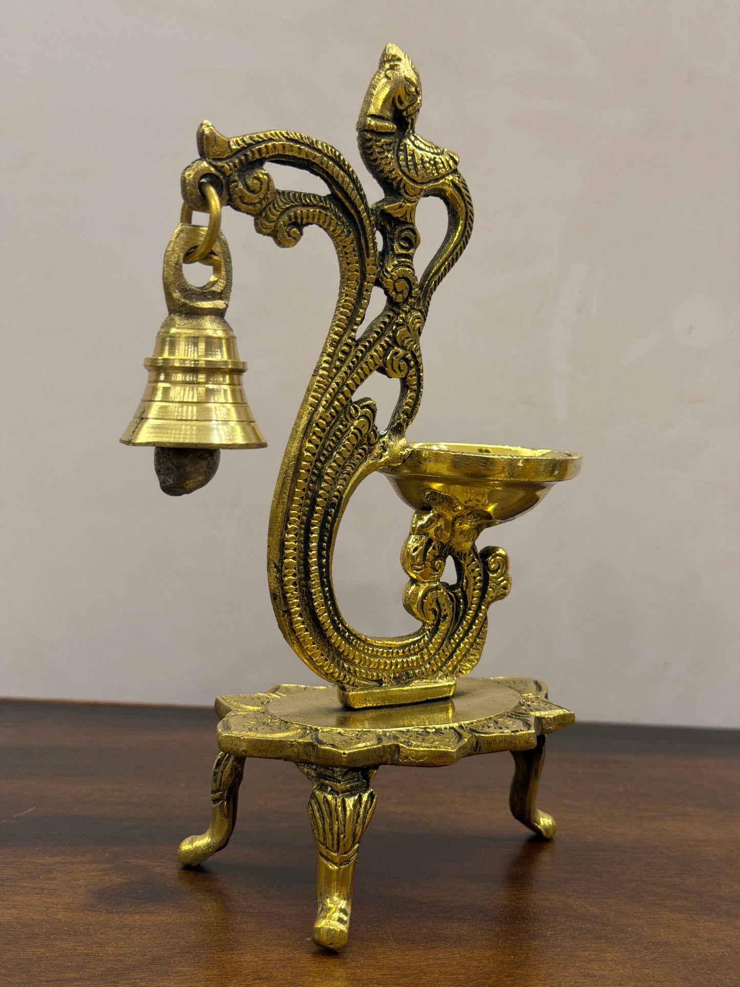 Beautifully carved brass diya with lamp and bell - 6.7 Inches Height