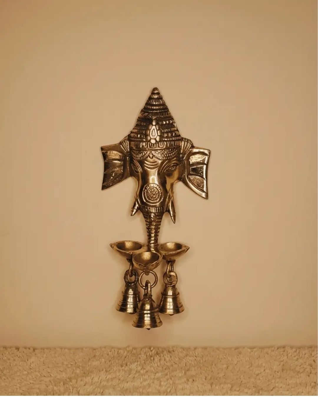 Brass Ganesha hanging with small diya and bells