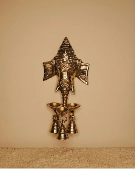 Brass Ganesha hanging with small diya and bells